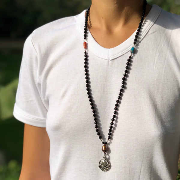 wearing black coral mala necklace